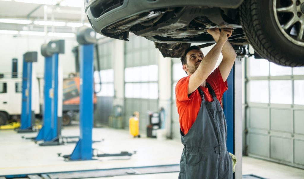 Car mechanic working at automotive service center